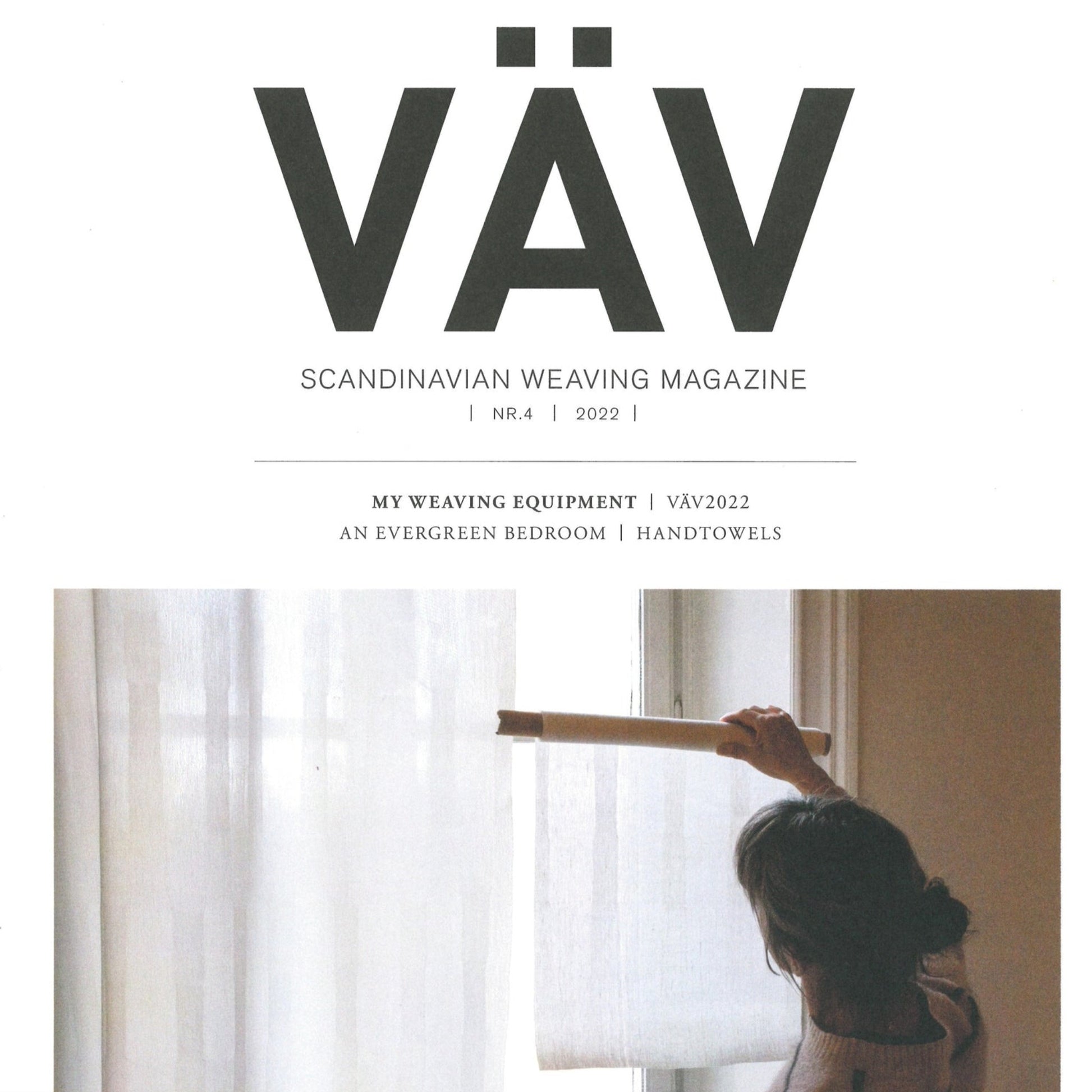 Cover of VÄV Magazine, VÄV Magasinet 4/22. The image depicts a person operating a weaving loom beside a window adorned with sheer curtains. Inside the magazine, you can find articles on "My Weaving Equipment," "An Evergreen Bedroom," and "Handtowels.