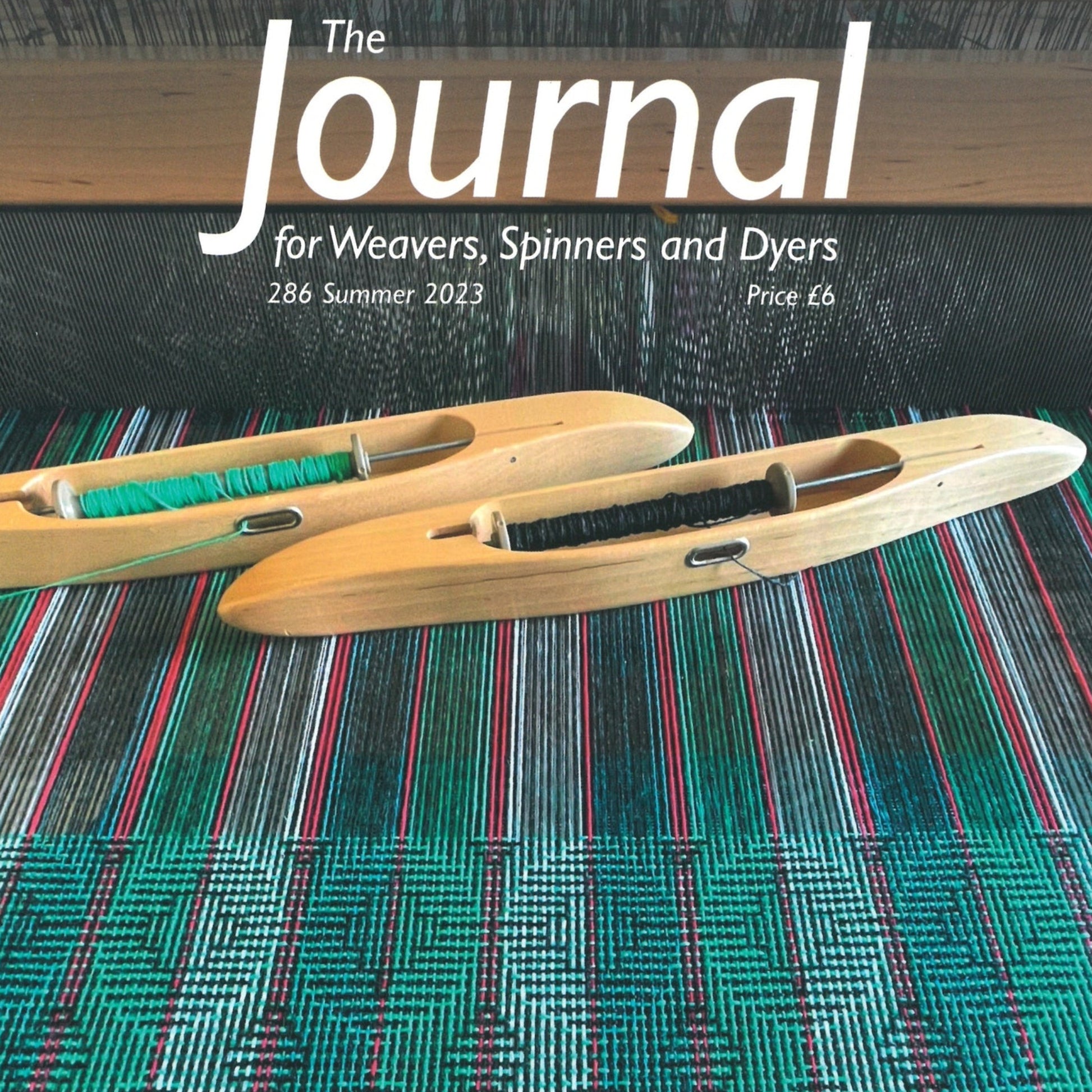 Cover of "The Journal For Weavers, Spinners and Dyers - UK - Issue 286, Summer 2023," by The Journal For Weavers, Spinners and Dyers. Features two wooden weaving shuttles with multicolored threads on a vibrant woven textile background, alongside articles on weaving drafts and botanical printing. Price is listed as £6.