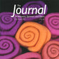 Cover of The Journal For Weavers, Spinners and Dyers - UK - Issue 279, Autumn 2021, offered at £6. Showcases vivid spirals of orange and purple wool set against a dark backdrop.