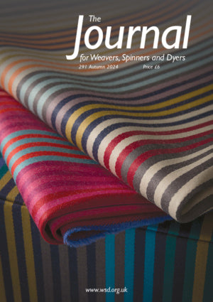 Presenting the cover of "The Journal for Weavers, Spinners and Dyers - UK - Issue 291, Autumn 2024." This colorful edition features an image of folded fabric with vibrant parallel stripes. Priced at £6, you can find more information at www.wsd.org.uk.