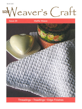 The cover of *Weaver's Craft Issue 29: Waffle Weave* by Plain Tabby Press features a captivating photo of a white waffle weave fabric, a painted tin with a floral design, and a heart-shaped soap on a white dish. The text highlights "Waffle Weave," "Threadings," "Treadlings," and "Edge Finishes"—perfect for your weaving projects. Priced at $8.00.