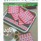 Cover of Weaver's Craft Issue 30: Rosepath on Opposites by Plain Tabby Press. The image displays a tray featuring woven red and white patterned napkins, a cup of hot chocolate with marshmallows, and two cookies. The text highlights phrases such as "On Opposites Bound Weave" and "Mirror-Image Selvedges," emphasizing the Rosepath technique.