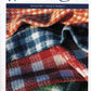 Cover of Weaver's Craft Issue 8: Gingham Kitchen Towels in Four Sizes of Checks by Plain Tabby Press. The image features vibrant woven towels with patterns in red, white, blue, and green gingham. This issue delves into topics such as gingham towels, altering yarn size, and exploring textures in weaving with little helpers.