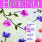 Cover of the "Rug Hooking Magazine June/July/August 2022" by Ampry Publishing features a floral design with purple and pink flowers against a green patterned background similar to an antique flower basket pattern. Headlines highlighted include: "Stories in Wool," "Cats, Cats, and More Cats," "A Visit to the Fair," "Show Binding," and "Appliqué Flower Basket.