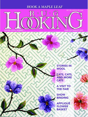 Cover of the "Rug Hooking Magazine June/July/August 2022" by Ampry Publishing features a floral design with purple and pink flowers against a green patterned background similar to an antique flower basket pattern. Headlines highlighted include: "Stories in Wool," "Cats, Cats, and More Cats," "A Visit to the Fair," "Show Binding," and "Appliqué Flower Basket.