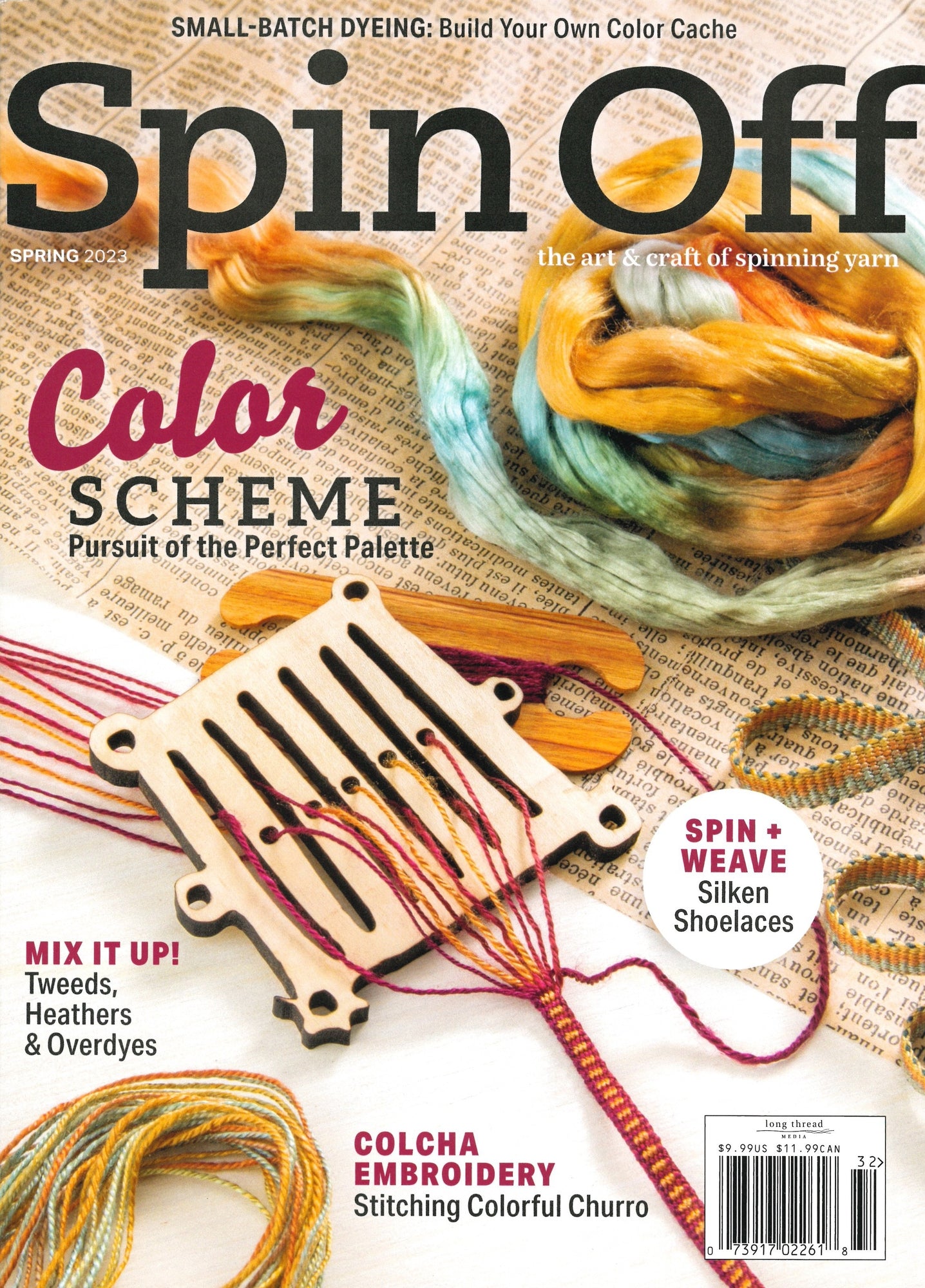 Cover of Long Thread Media's "Spin Off Spring 2023" magazine showcasing vibrant yarns and a weaving tool, accompanied by articles on small-batch dyeing, color palettes, and colcha embroidery. The textured paper background adds to the crafty theme.