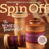 Magazine cover titled "Spin Off Fall 2022" from Long Thread Media, showcasing wooden bobbins loaded with multicolored yarn. The text includes highlights such as "The Wheel Reinvented" and "Tweed Socks to Spin, Knit & Love." Delve into Indigenous Design elements while spinning yarn and receive advice on Antique Wheel Rehab to help make the perfect spinning wheel selection.