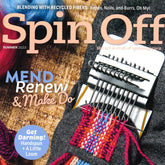 Close-up of the Long Thread Media "Spin Off Summer 2023" magazine cover showcasing colorful yarn on a handspun loom. It features articles on recycled fibers and knitting scrappy socks, set against a vibrant backdrop of wool fibers.