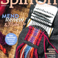 The cover of "Spin Off Summer 2023," a magazine by Long Thread Media, features an intricately handspun loom dressed with vibrant yarn and knitting tools. Key highlights are titled "Mend, Renew, & Make Do," "Get Darning," and "Knit Scrappy Socks." The edition focuses on recycling by celebrating crafts made with recycled fibers and creative handmade artistry.