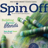 The magazine cover titled "Spin Off Winter 2022" by Long Thread Media showcases textured, multicolored yarn rolls. Headline topics include "Building Better Blends" and "Rare-Breed Tweed: Card Your Own," emphasizing the beauty of wool grease.