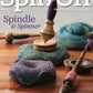 The cover of "Spin Off Fall 2024" by Long Thread Media showcases a wooden spindle adorned with handspun yarn resting on a textured mat. Additional spindles and components are visible in the background, with text promoting articles about the physics of supported spindles, the use of distaffs, and knitting socks tailored for spinners.