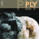 A magazine cover from PLY Magazine showcases two fluffy rabbits, one gray and the other white, cuddled closely like a pair of cozy kittens. Featured prominently at the top is the title of "PLY - The Magazine for Handspinners, Issue 28, Spring 2020: Fur.