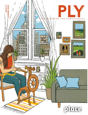 A woman sits in a cozy room, spinning yarn with a spinning wheel. The room features a large window offering a view of city buildings, potted plants, and framed pictures adorning the walls. A striped rug lies on the floor next to a sofa with cushions. The Summer 2023 cover of PLY Magazine showcases Issue 41 titled "Place," exploring various spinning techniques.