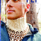 A person dressed in a high-collared, hand-knitted sweater crafted from thick, cozy yarn and a blue jacket is standing outdoors. The magazine cover displays the following text: "PLY Magazine" and "Issue 39, Winter 2022: Neck and Shoulders.