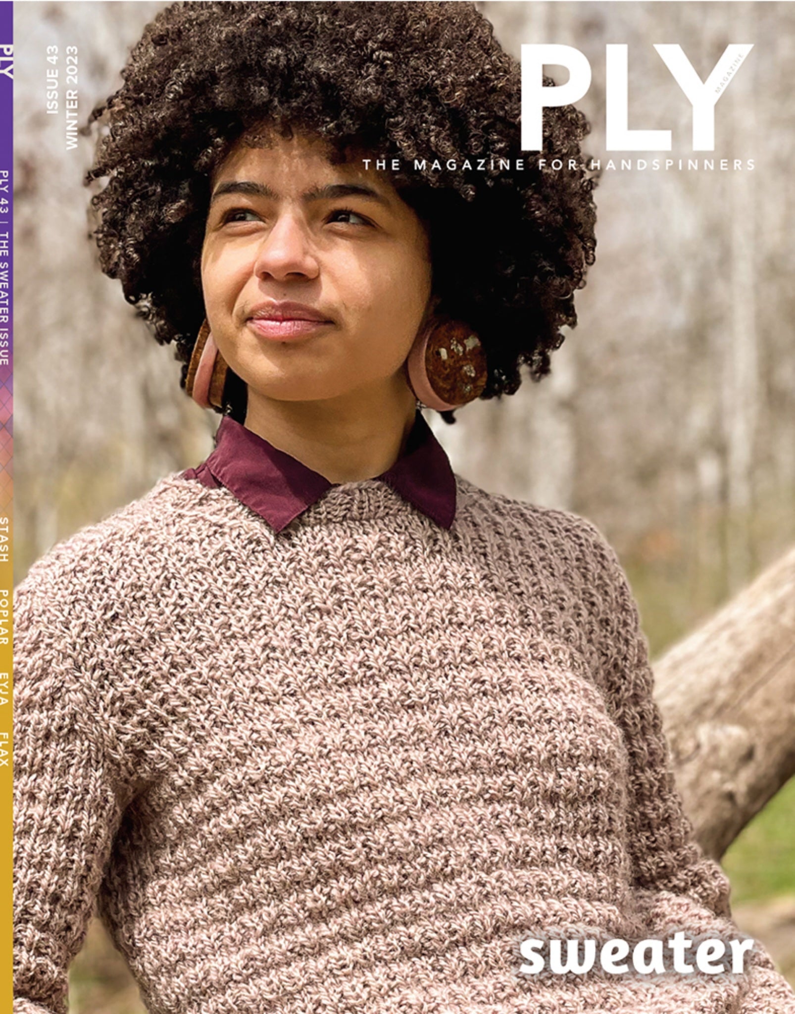 A person with curly hair, draped in a textured sweater and adorned with large earrings, gazes thoughtfully to the side in a wooded setting. Featured on the cover of PLY Magazine's Winter 2023 edition (Issue 43), the main headline highlights "handspun sweaters," epitomizing cozy creativity.