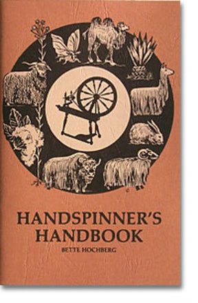 The cover of "Handspinner's Handbook" by Bette Hochberg, a Foxglove Fiberarts Supply product, features a central spinning wheel surrounded by illustrations of fiber-producing animals and plants. These include a butterfly, camel, alpaca, llama, bison, sheep, goat, and rabbit—all set against a rustic brown background.