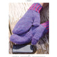 Two hands wearing the Delightful Mittens to Spin Year-Round, a design from Long Thread Media, with purple knit and pink-striped cuffs are resting on a weathered wooden surface. A black smartphone is placed nearby on the same surface.