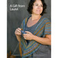 A person with short dark hair, wearing a multicolored knitted shawl over a gray top, is holding a copy of the "Spin Off Presents: Lovely Lace: 6 Projects to Spin and Knit - eBook Printed Copy" by Long Thread Media, looking slightly to the side. The text "A Gift from Laurel" is written at the top against a plain gray background.