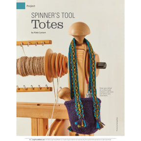 A rigid heddle loom with yarn wound tightly around its warp. Attached to the loom is a small knit pouch in a dark purple color with blue and green braided straps. The background is plain and light-colored. The text reads "Spin Off Presents: Bandweaving Using Rigid Heddles and Inkle Looms - eBook Printed Copy by Long Thread Media.