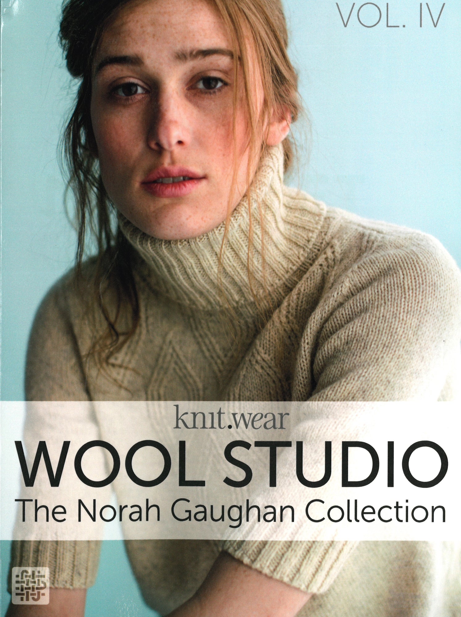 Cover of "Wool Studio Vol. 4: The Norah Gaughan Collection" by Ingram Content. It features a woman wearing a cream-colored, high-neck knitted sweater, posing against a pale blue background. "Wool Studio Vol. 4" is prominently displayed in bold letters, highlighting the exquisite knitting patterns within.