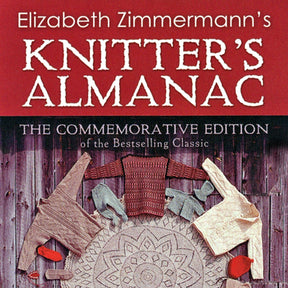 Cover of "Elizabeth Zimmermann's Knitter's Almanac - Commemorative Edition" by Dover Books. The title is in white on a red background, featuring sweaters and other knitted garments arranged in a circular pattern on a wooden surface, perfect for intermediate knitters.