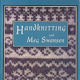 The cover of "Handknitting with Meg Swansen" by Schoolhouse Press showcases a blue border encircling a knitting pattern background, which features alternating rows of white and grey knit stitches. These stitches evoke the detailed designs typical of a Swedish Dubbelmössa. Centered within a blue box on the cover are the title and author's name.