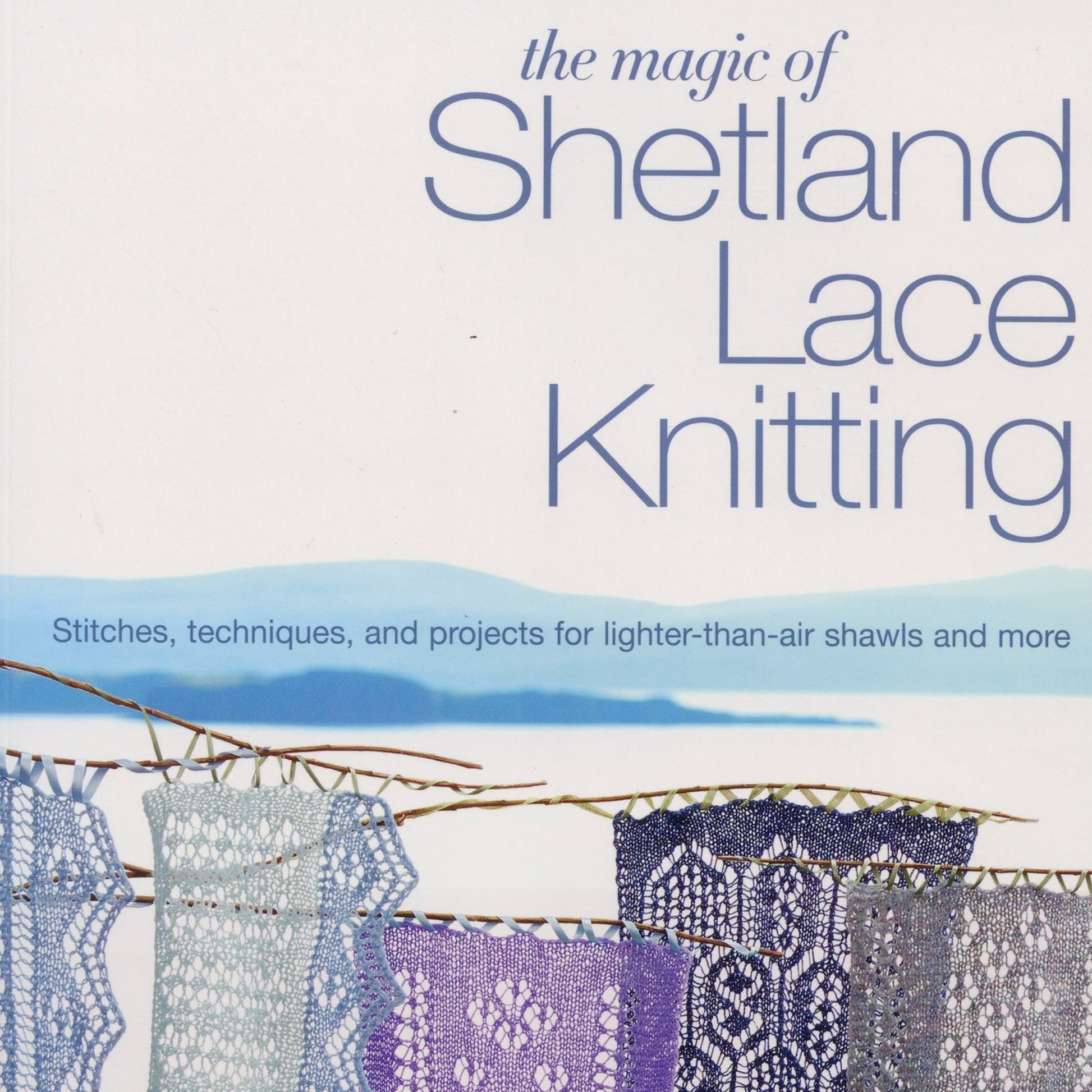 Cover of the MacMillan/MPS Holdings LLC book "The Magic of Shetland Lace Knitting," featuring the subtitle, "Stitches, techniques, and projects for lighter-than-air shawls and more." The background showcases a tranquil lake scene adorned with rows of meticulously crafted lace fabric—ideal for both beginner knitters and passionate enthusiasts.