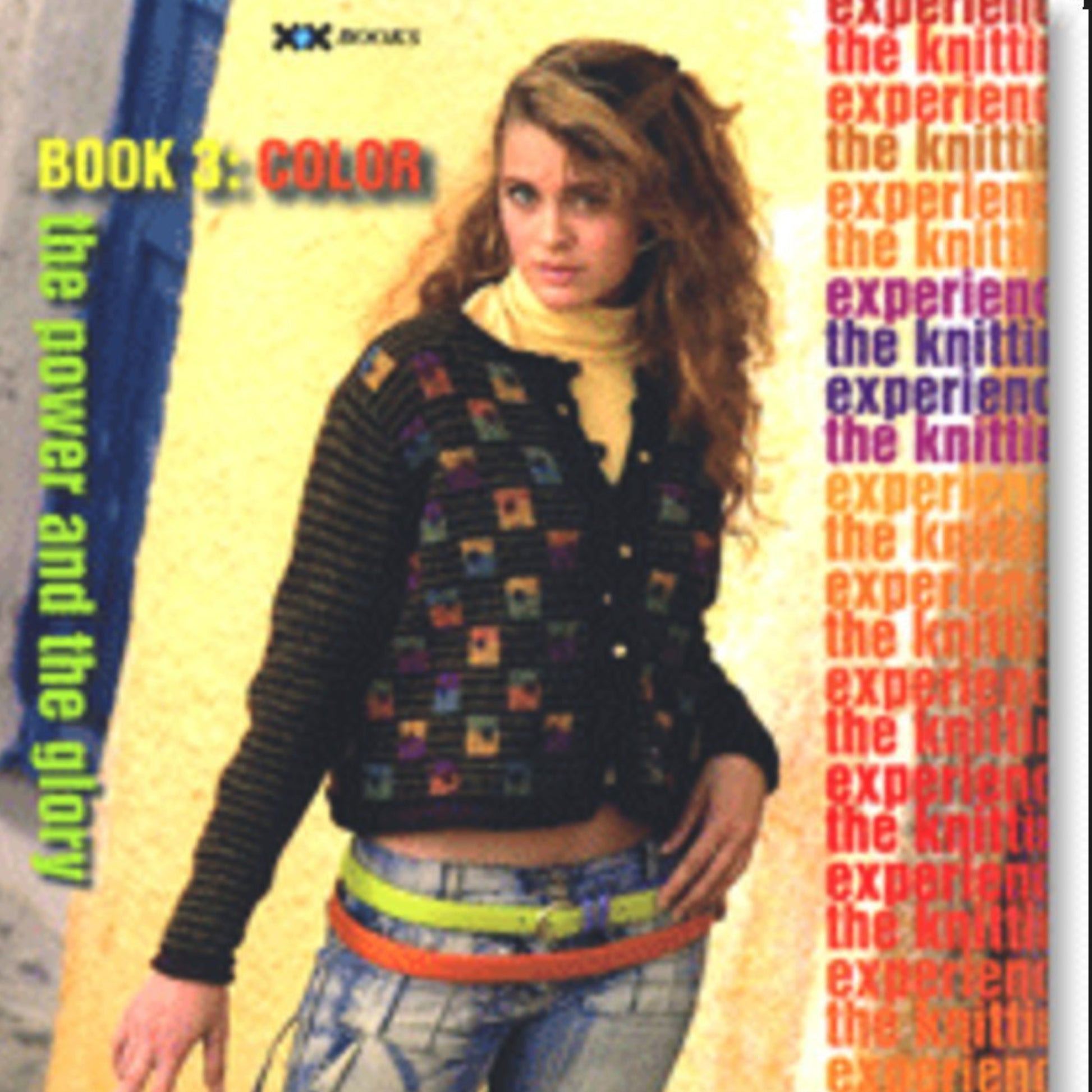 The cover of "The Knitting Experience Book 3: Color" by XRX showcases a young woman with long, curly hair wearing a black, multicolored knitted sweater and a yellow belt over jeans, set against a vibrant backdrop. It's perfect for those eager to explore advanced color techniques.