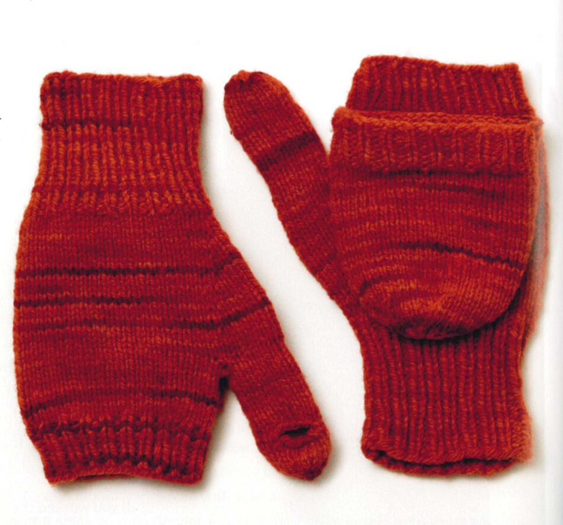 Hand-knitted by a knitting expert, the Knit Mitts - Your Hand-Y Guide to Knitting Mittens & Gloves by Ingram Content comes in a vibrant red-orange color with a darker stripe pattern. One glove's fold-over mitten flap is shown unfolded while the other is folded, allowing easy conversion from fingerless mittens to full mittens. Customize patterns as you wish with this thick wool yarn design.