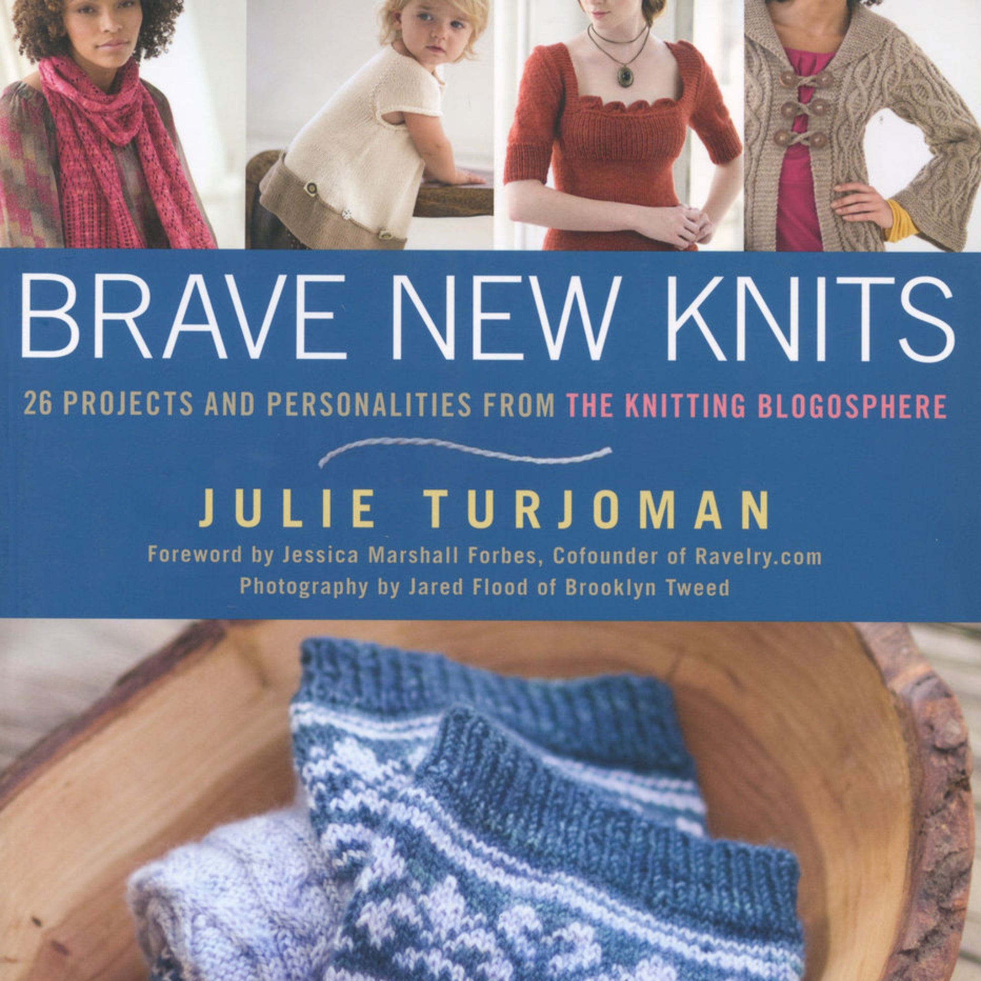 The cover of "Brave New Knits" by Julie Turjoman, published by Ingram Content, showcases people modeling hand-knitted garments and includes a close-up of blue and white knitted socks in a wooden bowl. This book delves into knitting projects and personalities from the knitting blogosphere, merging tradition with modern technology.