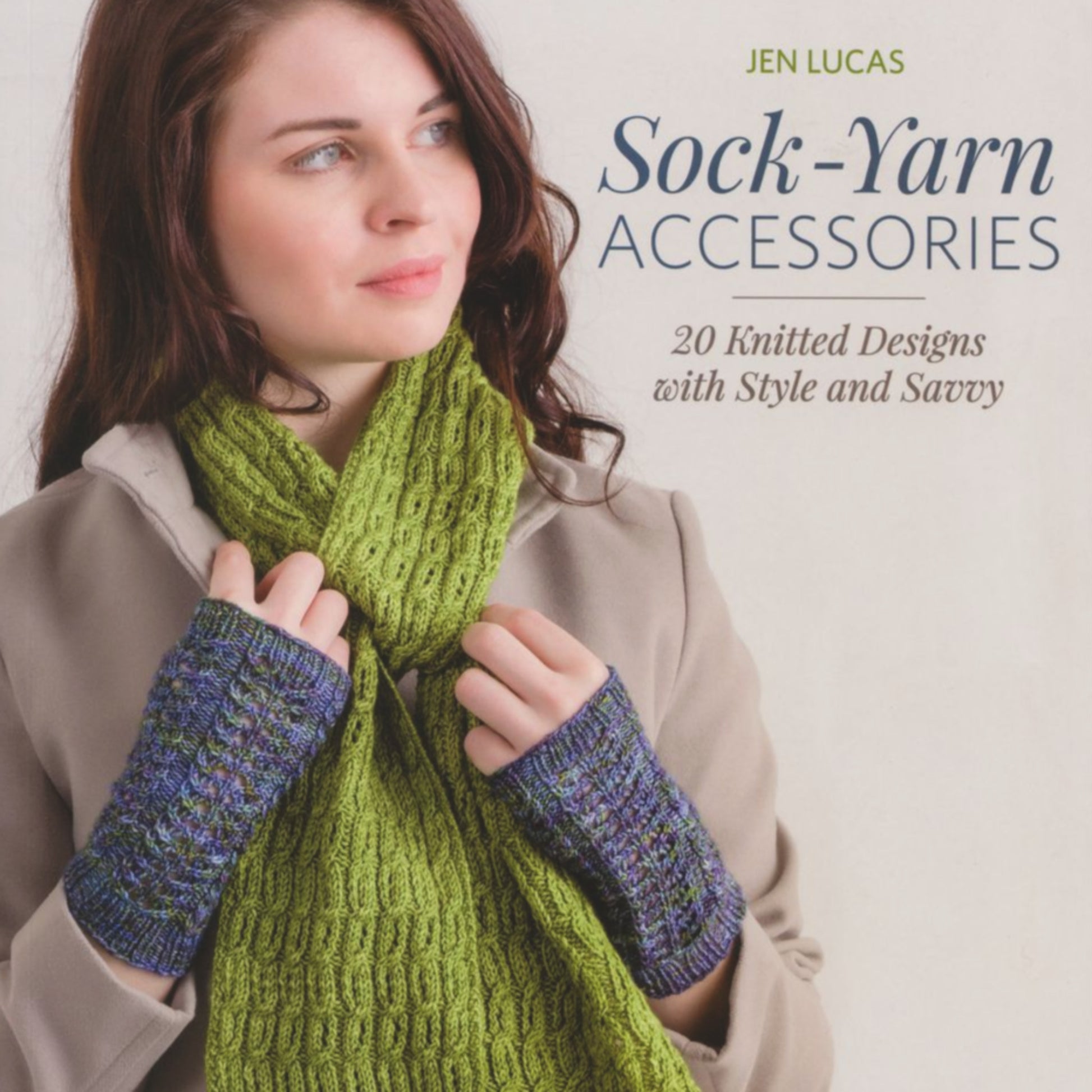 A woman wearing a beige coat models a vibrant lime-green knitted scarf and blue-green fingerless mitts. The image promotes the book titled "Sock-Yarn Accessories - 20 Knitted Designs with Style and Savvy" by Martingale & Co, featuring 20 stylish and savvy knitting patterns that are quick-to-stitch.