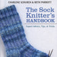 A close-up image of the cover of "The Sock Knitter's Handbook," published by Martingale & Co. and authored by Charlene Schurch and Beth Parrott, showcases a knitted blue sock. The cover includes the subtitle "Expert Advice, Tips, & Tricks" alongside invaluable cast-on techniques to elevate your sock knitting journey.