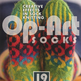 Cover of the book "Op-Art Socks - Creative Effects in Sock Knitting" by Ingram Content. It showcases vibrant, multi-colored knitted socks with geometric patterns and textured knitting. The eye-catching socks stand out against a dark background, highlighting the detailed and colorful optical illusion designs.