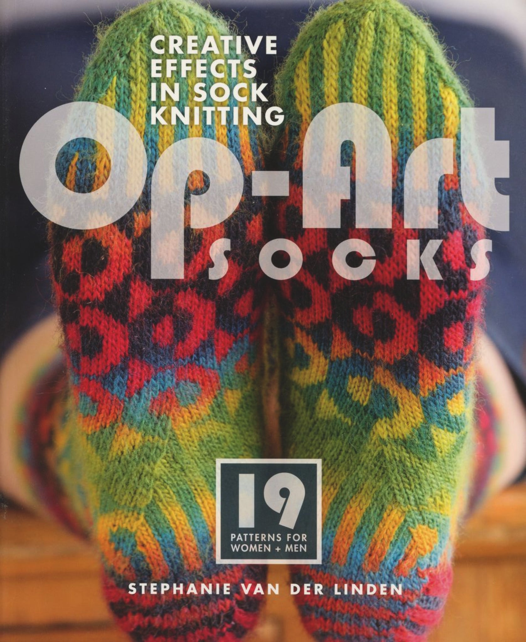 Cover of the book "Op-Art Socks - Creative Effects in Sock Knitting" by Stephanie van der Linden, published by Ingram Content. Features a pair of colorful knitted socks with an intricate pattern, perfect for fans of colorwork sock patterns. The cover also highlights "19 Patterns for Women + Men.