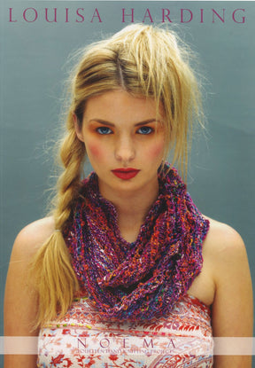 A blonde woman with her hair styled in a side braid is posing against a grey background, wearing a multicolored knitted scarf and a floral top. The text "LOUISA HARDING" appears at the top, while "NOEMA BOOK FROM LOUISA HARDING" by Knitting Fever / Euro Yarns is featured at the bottom, highlighting fourteen hand knitting projects with Noema yarn.