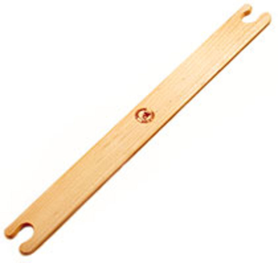 The Leclerc Stick Shuttle by Leclerc Looms features a design with two notched ends and a smooth, flat surface. A small, circular logo or emblem is engraved at the center of this sturdy shuttle which appears to be made of light-colored wood, making it perfect for beating the weft in your weaving projects.