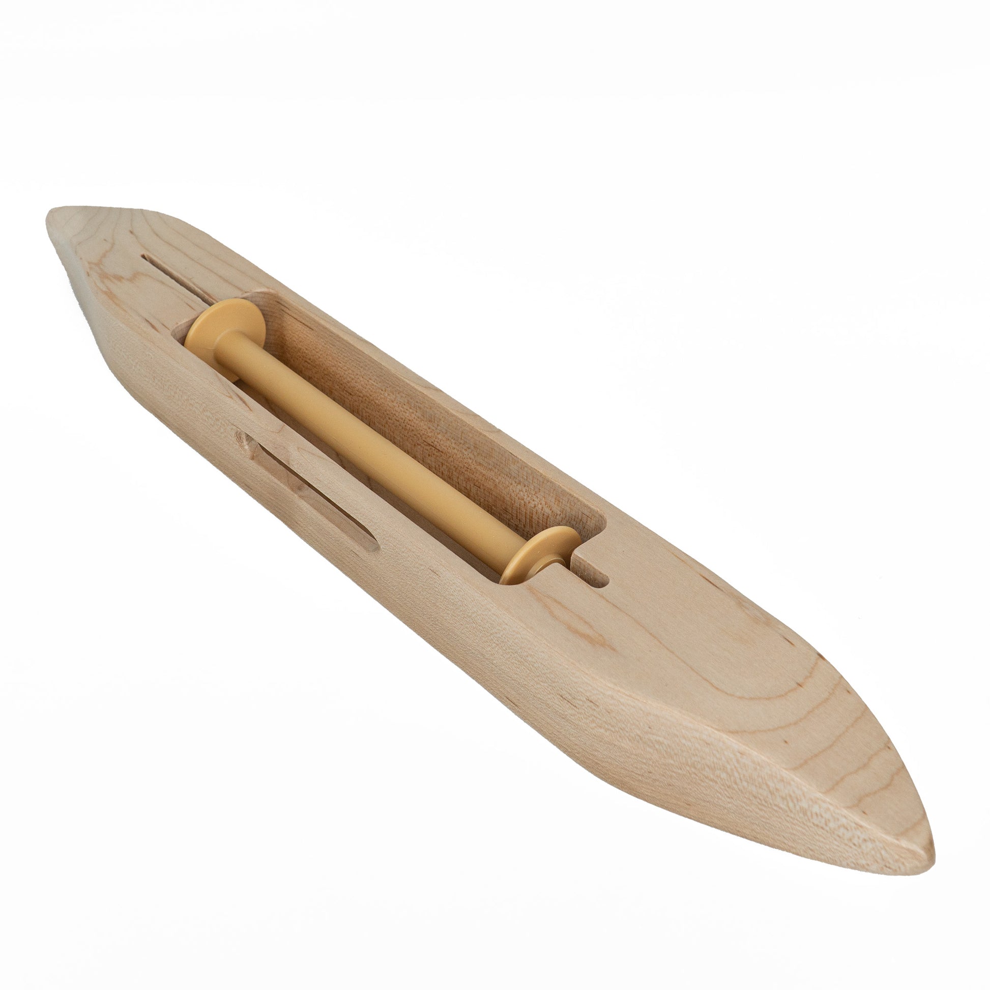 The Leclerc 15" Closed Bottom Boat Shuttle, crafted by Leclerc Looms, features a pointed, canoe-like shape and houses a 6" bobbin in its central section. This shuttle is known for its smooth, light wood finish and is used to pass the weft yarn through the warp threads during the weaving process.