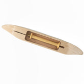 The Leclerc 11" Boat Shuttle, crafted by Leclerc Looms, is a wooden weaving tool with a light finish, featuring a central groove that holds a yellow bobbin. Its pointed ends and smooth surface make it ideal for use on a loom.