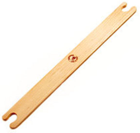 The Leclerc Stick Shuttle from Leclerc Looms is a light wooden weaving shuttle with a smooth finish, featuring a small engraved logo in the center. Both ends of the shuttle are slightly curved with notches for holding the thread, making it ideal for beating the weft. It is positioned against a plain white background.