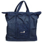 A large, dark blue denim tote bag with two shoulder straps and a small front pocket. The front pocket features a logo reading "Leclerc Looms" along with a small emblem. Ideal for crafters, this spacious bag can easily carry your Leclerc Voyageur Table Loom, featuring a square base and a zippered top closure.