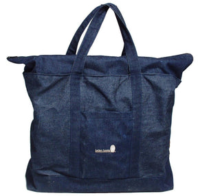 A large, dark blue denim tote bag with two shoulder straps and a small front pocket. The front pocket features a logo reading "Leclerc Looms" along with a small emblem. Ideal for crafters, this spacious bag can easily carry your Leclerc Voyageur Table Loom, featuring a square base and a zippered top closure.