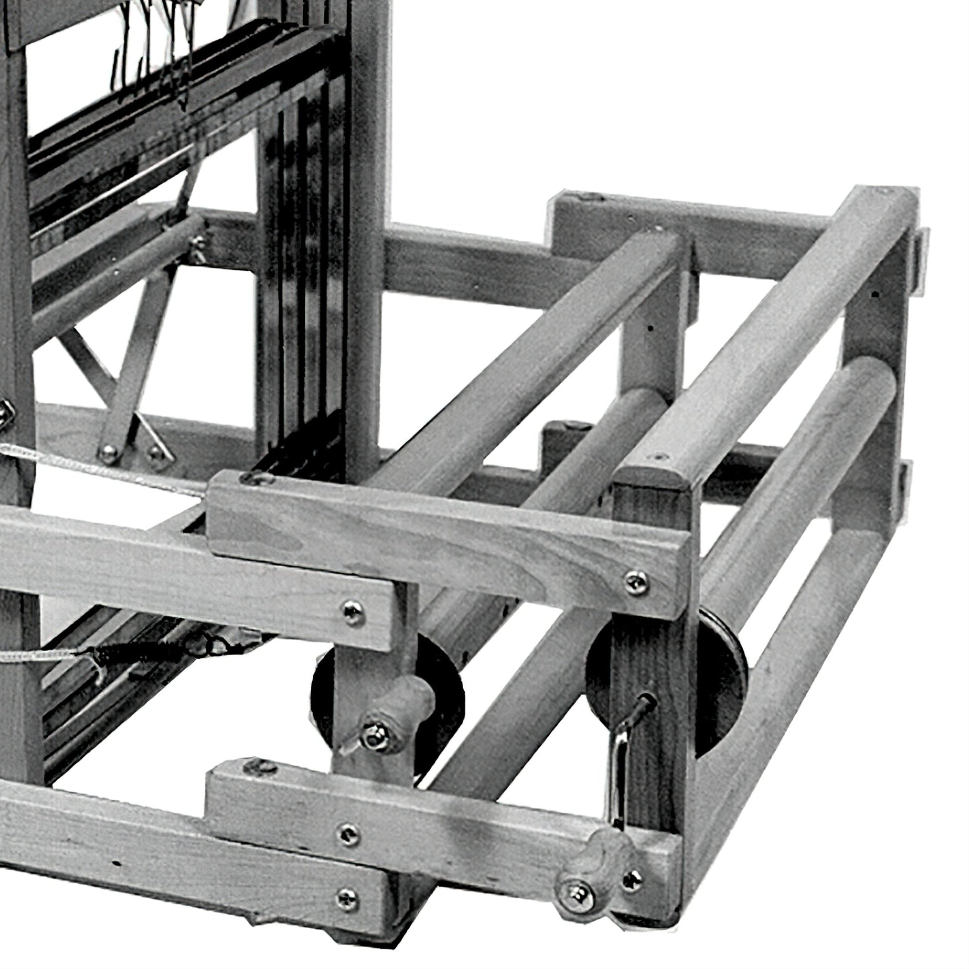 A black and white image of the Leclerc Double Warp Beam Dorothy & Voyageur by Leclerc Looms. The wooden mechanical loom boasts a sturdy rectangular frame with numerous rods and strings. It features various gears, mechanisms, and a thread beam designed for weaving fabric, showcasing intricate design and craftsmanship.
