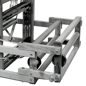 A black and white image of the Leclerc Double Warp Beam Dorothy & Voyageur by Leclerc Looms. The wooden mechanical loom boasts a sturdy rectangular frame with numerous rods and strings. It features various gears, mechanisms, and a thread beam designed for weaving fabric, showcasing intricate design and craftsmanship.
