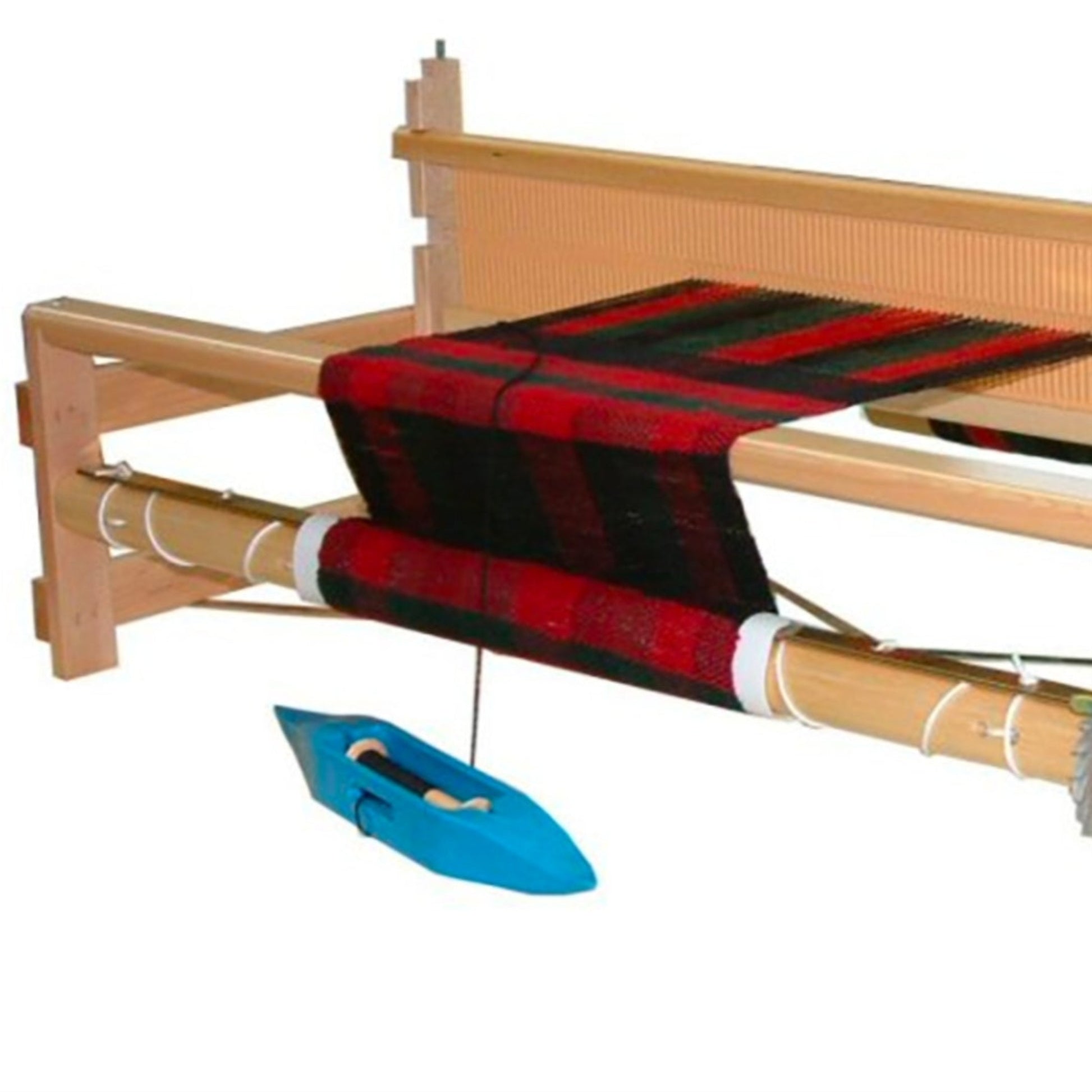 The Leclerc Bergere Rigid Heddle Loom, 24" from Leclerc Looms features a red and black patterned fabric being woven on its large frame. The loom is equipped with essential weaving tools including a beater, warp threads, and a shuttle positioned below. Precision is maintained with ratchet brakes, all set against a plain white background.