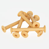 A set of six beige Leclerc Plastic Bobbins from Leclerc Looms, with flared ends and circular holes in the center, is arranged in an intersecting pattern against a plain white background. The bobbins feature raised text around the edges.