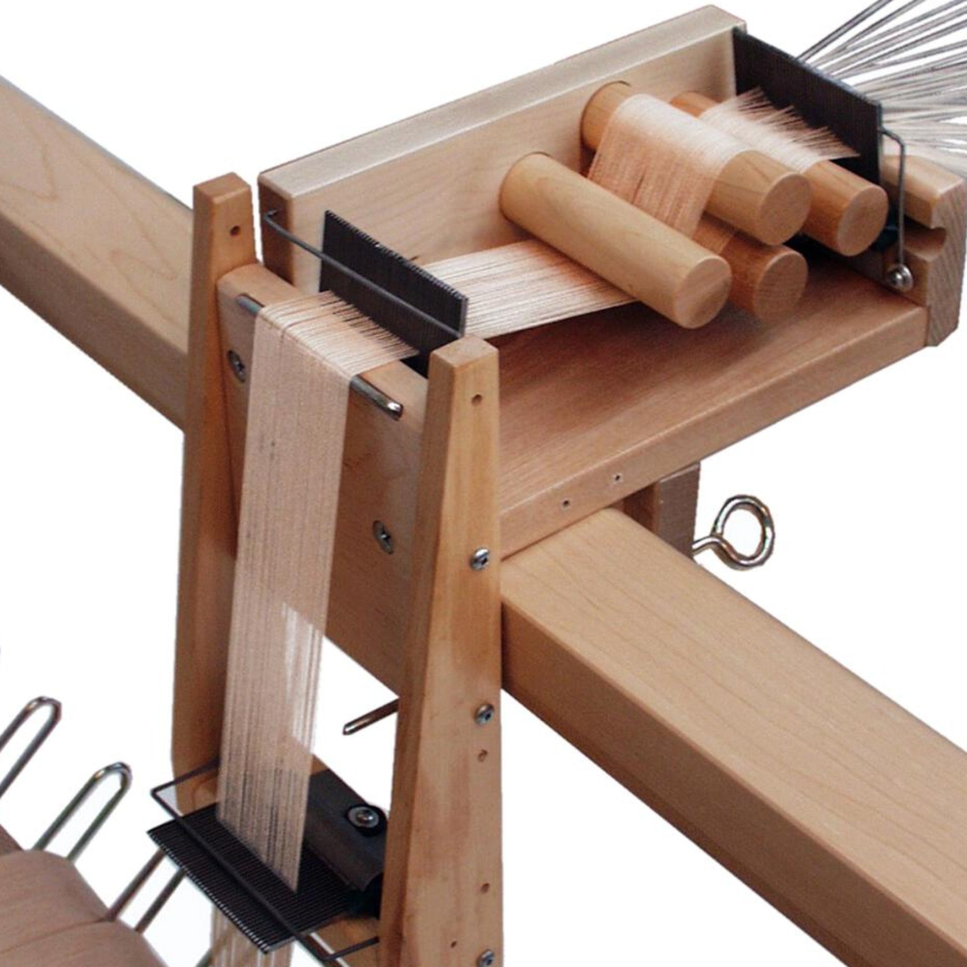 A close-up of the Leclerc Tension Box Extension by Leclerc Looms features an adjustable comb. The extension has several vertical wooden pegs and horizontal bars that hold threads in place for weaving. The setup appears organized and functional, designed for intricate textile work.