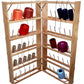 The Leclerc Studio Bobbin and Cone Rack, crafted by Leclerc Looms, stands open to display a variety of yarn spools in different colors. The rack features multiple shelves with pegs that hold up to fifty bobbins in red, blue, purple, beige, and white yarn. Each spool has strings hanging down to make threading easier.