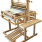 The Leclerc Table Loom Stand for Dorothy 24", featuring 4 shafts, side shelves, and 6 treadles, crafted from light-colored wood, is designed for convenient manual textile production with an adjustable loom stand.