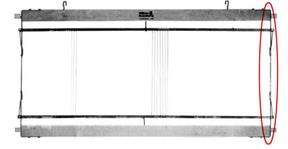 A Leclerc Harness/Shaft frame end piece with heddle bar support spring hangs horizontally with two hooks on the top side and a red oval encircling an area on the right side. The frame, typical of a Leclerc Loom, has five evenly spaced vertical lines extending across its width in the middle.