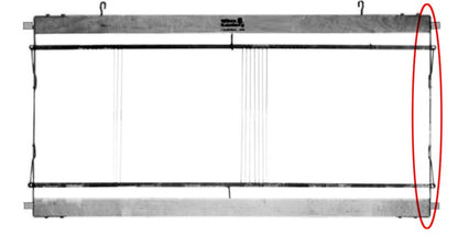 A rectangular metal frame, identified as the Leclerc Harness/Shaft frame end piece with heddle bar support spring from Leclerc Looms, is suspended from two hooks at the top and consists of multiple thin horizontal and vertical wires. A large red oval is drawn around the right side of the frame, perhaps highlighting a specific metal end piece of interest.